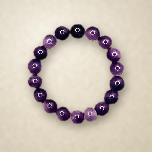 Amethyst beaded bracelet, photographed on warm paper