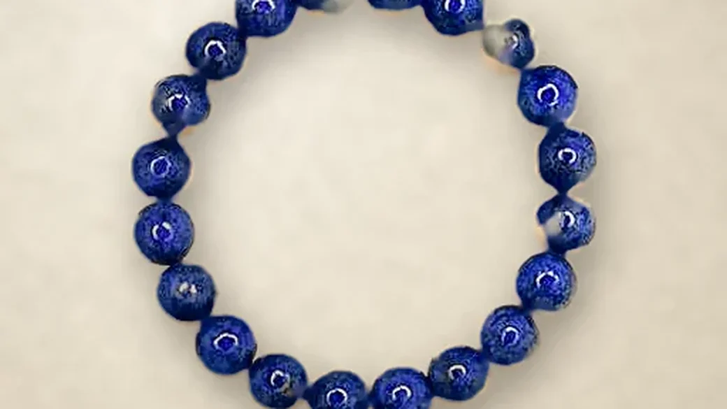 A lapis lazuli bracelet on warm paper
