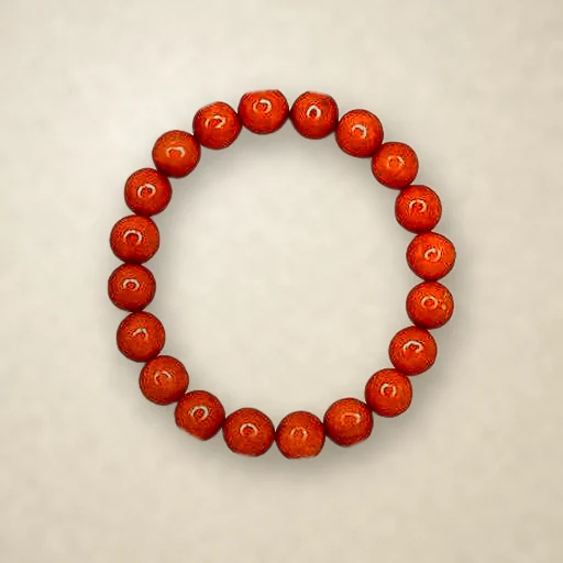 Red Jasper beaded bracelet, photographed on warm paper