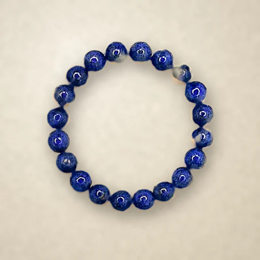 Lapis Lazuli beaded bracelet, photographed on warm paper