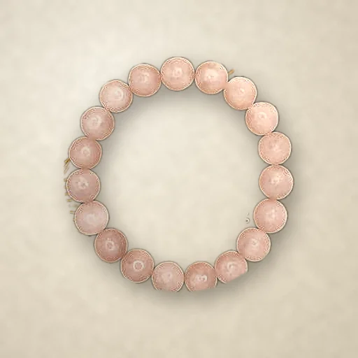 Rose Quartz beaded bracelet, photographed on warm paper