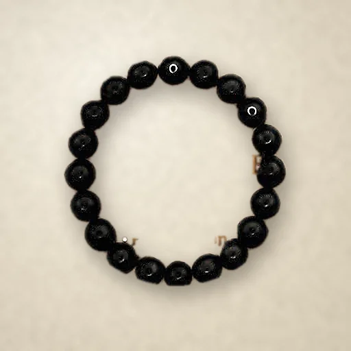 Black Tourmaline beaded bracelet, photographed on warm paper